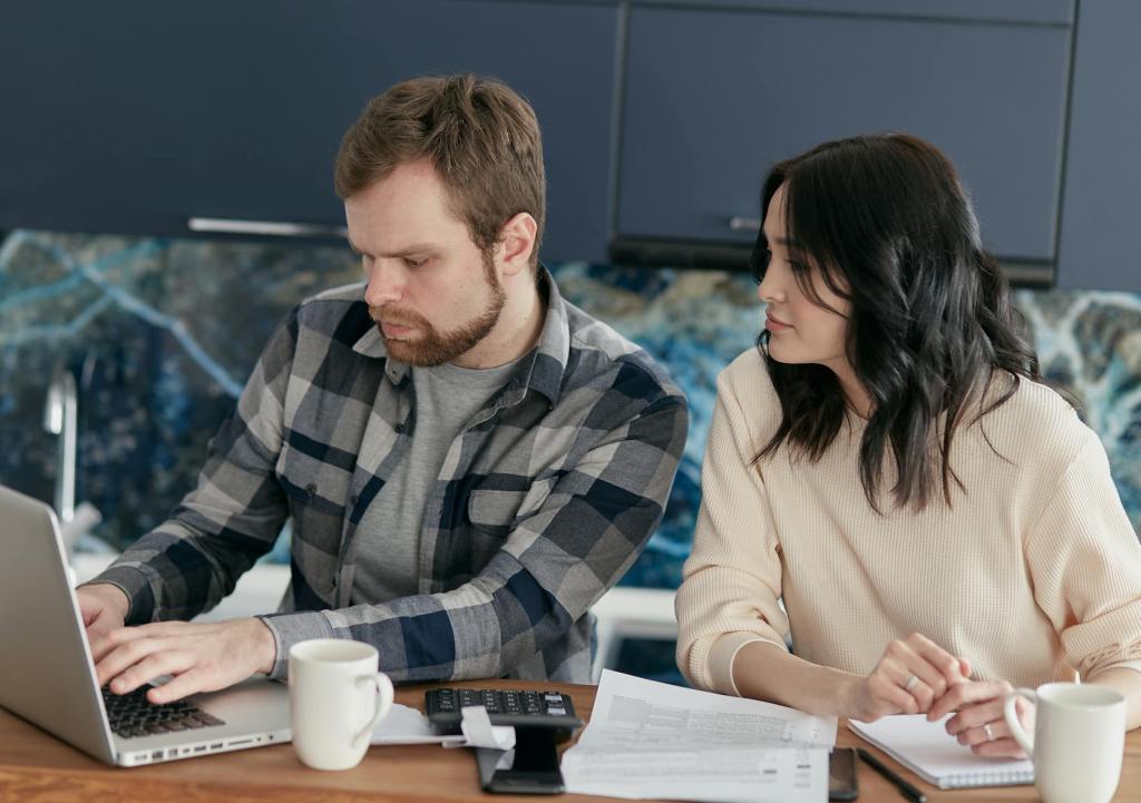 a couple looking at the laptop together