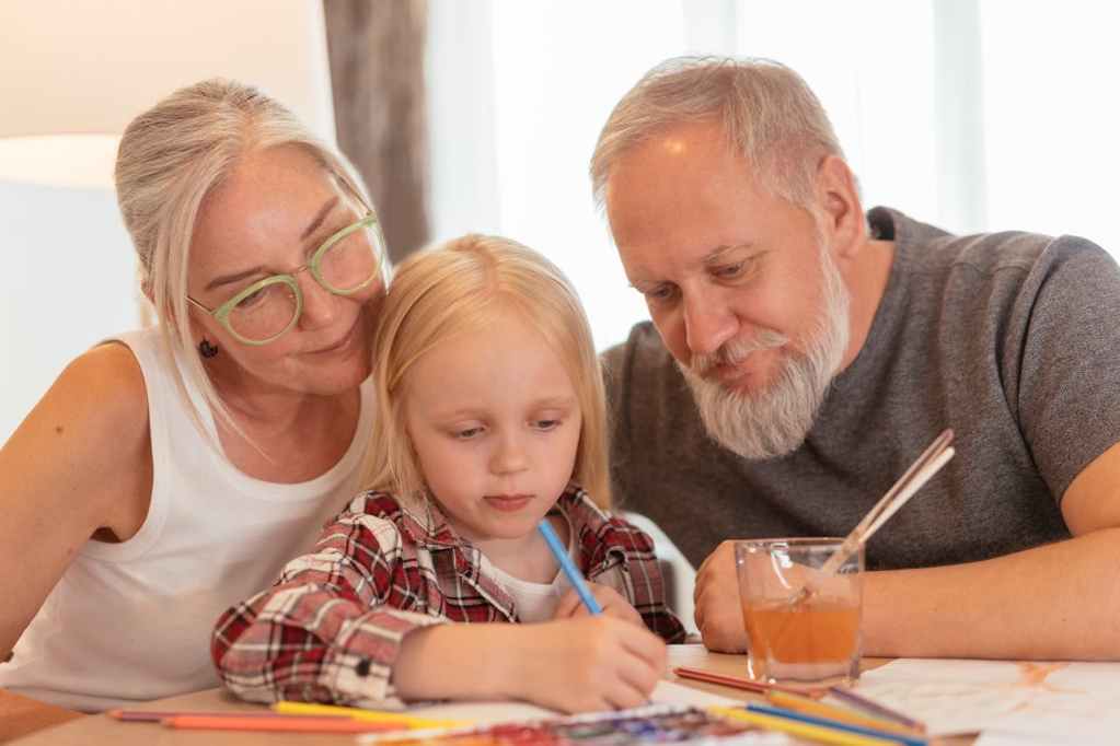 grandparents colouring in with granddaughter